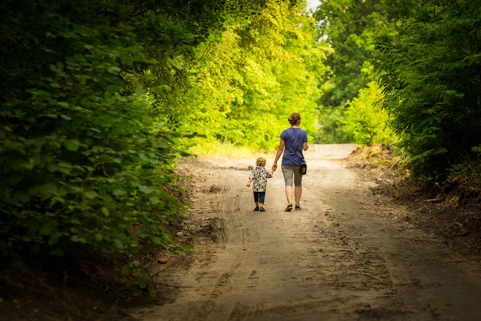 Mother and Child Walking by Forest Path